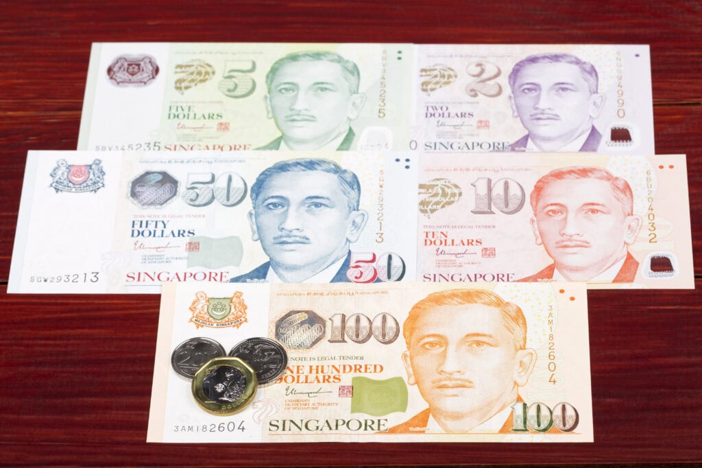 Singapore banknotes and coins displayed together.